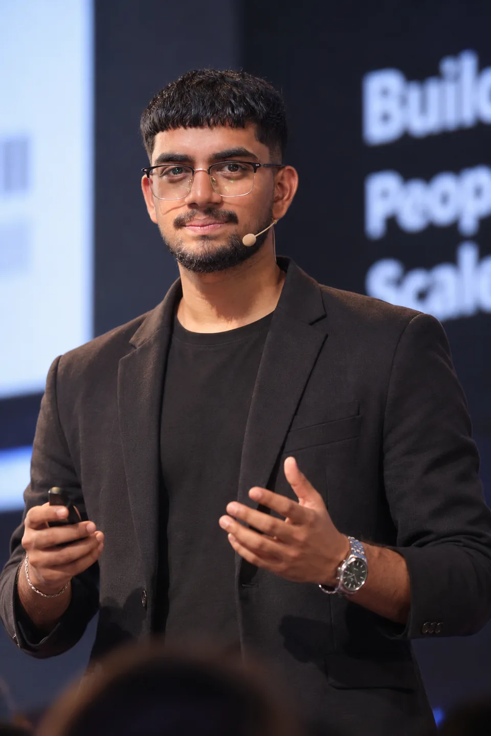 Sahil Saudagar speaking on stage about ideas, communication, and business